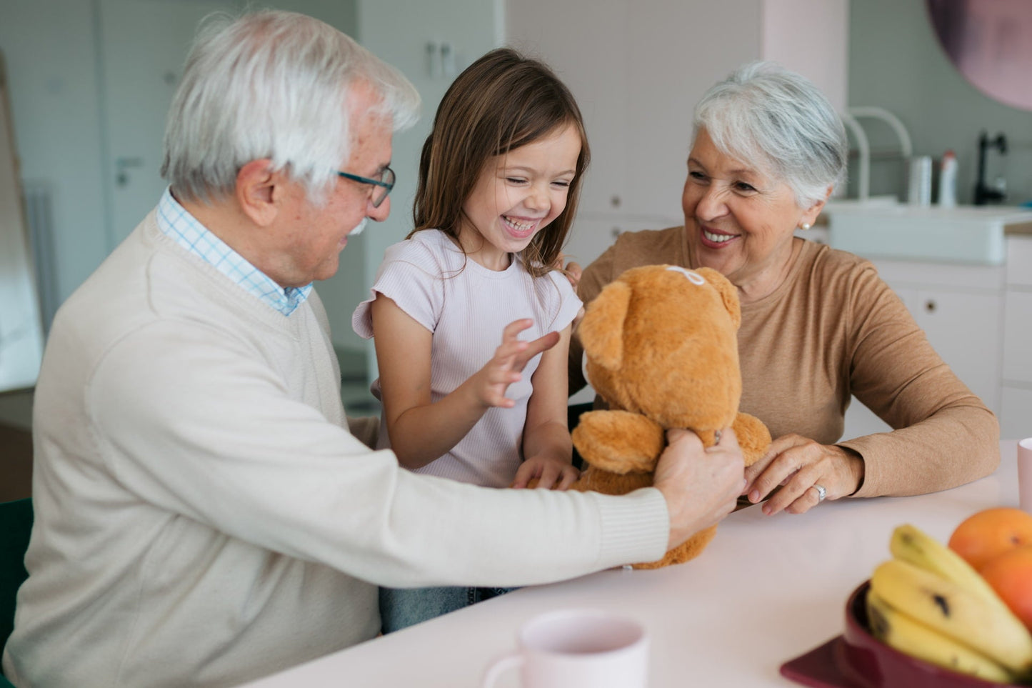 Grandparents gifting granddaughter bear