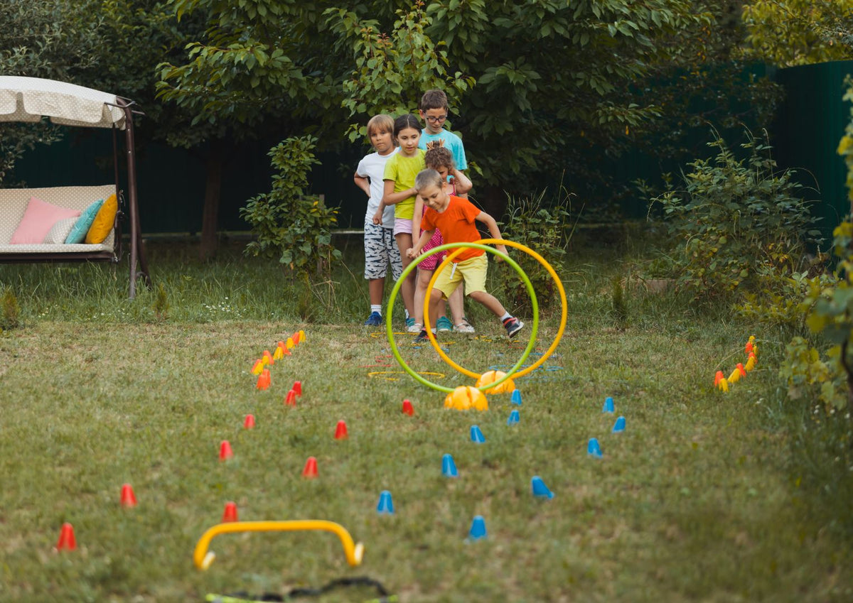 Kids Playing With Hoops And Cones